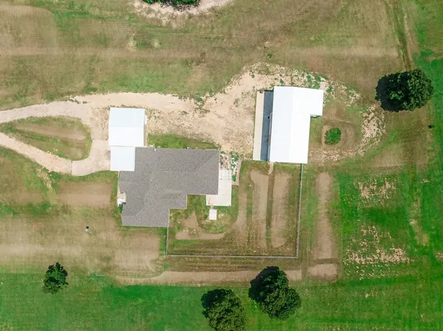 an aerial view of a house with a yard