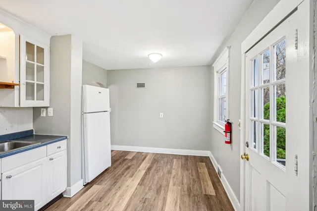 a view of front door with wooden floor