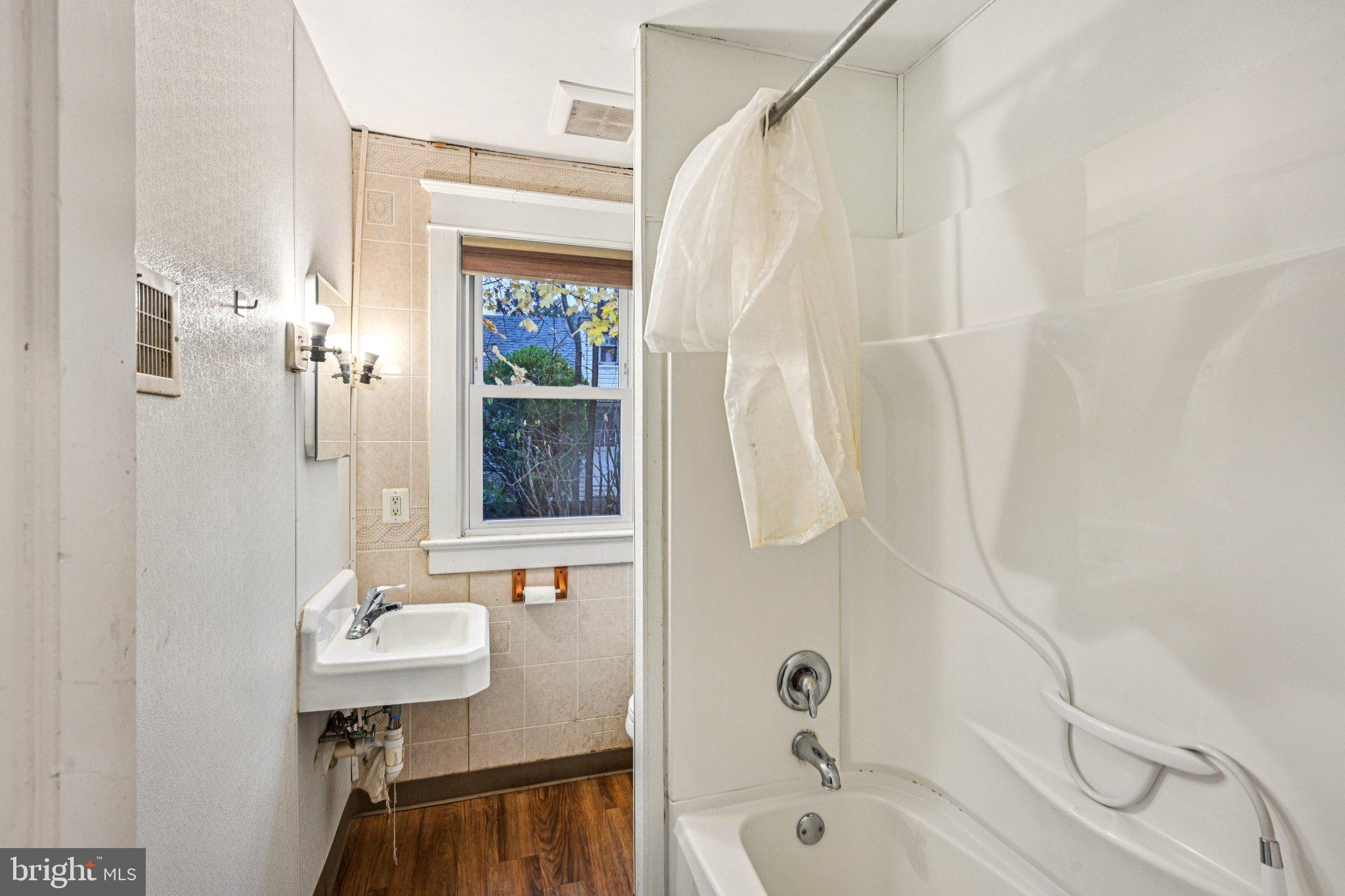 12 Normal Boulevard Glassboro, NJ 08028 - Photo 15 of 28 a bathroom with a sink a mirror and a shower