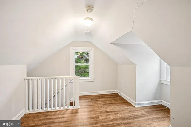 a view of room with window and hardwood floor
