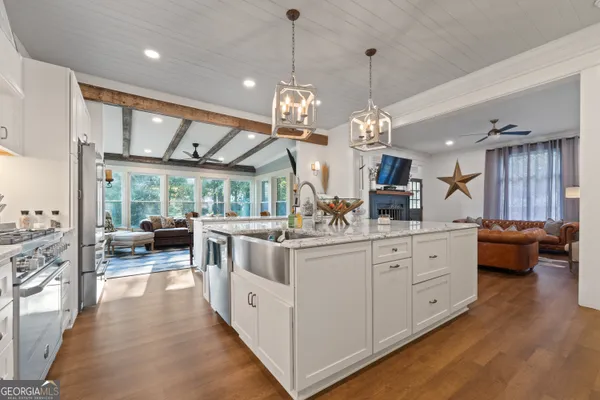 a kitchen with cabinets and chairs