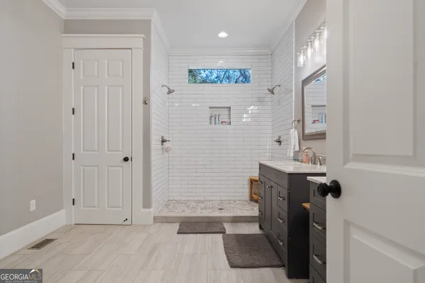 a spacious bathroom with a double vanity sink mirror and double