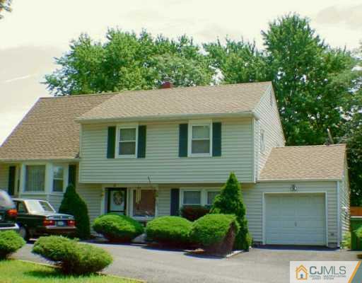 275 Old Post Road Edison, NJ 08817 - Photo 1 of 8 a front view of a house with a yard and garage