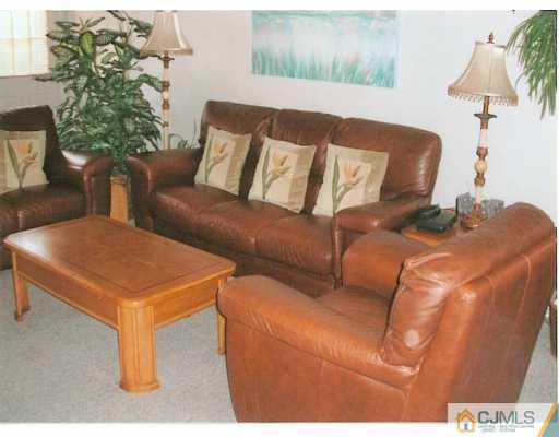275 Old Post Road Edison, NJ 08817 - Photo 3 of 8 a blue couch sitting in a living room with a table