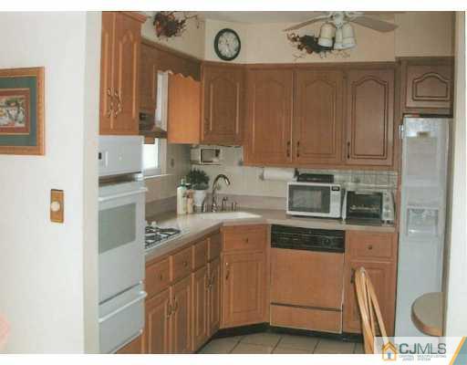 275 Old Post Road Edison, NJ 08817 - Photo 7 of 8 a kitchen with a stove a sink and a refrigerator