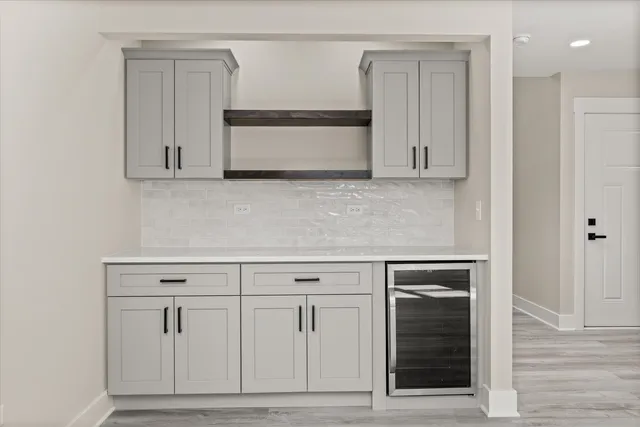 a kitchen with white cabinets and white appliances