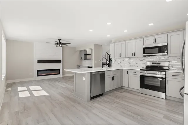 a kitchen with a white wooden cabinets and white appliances