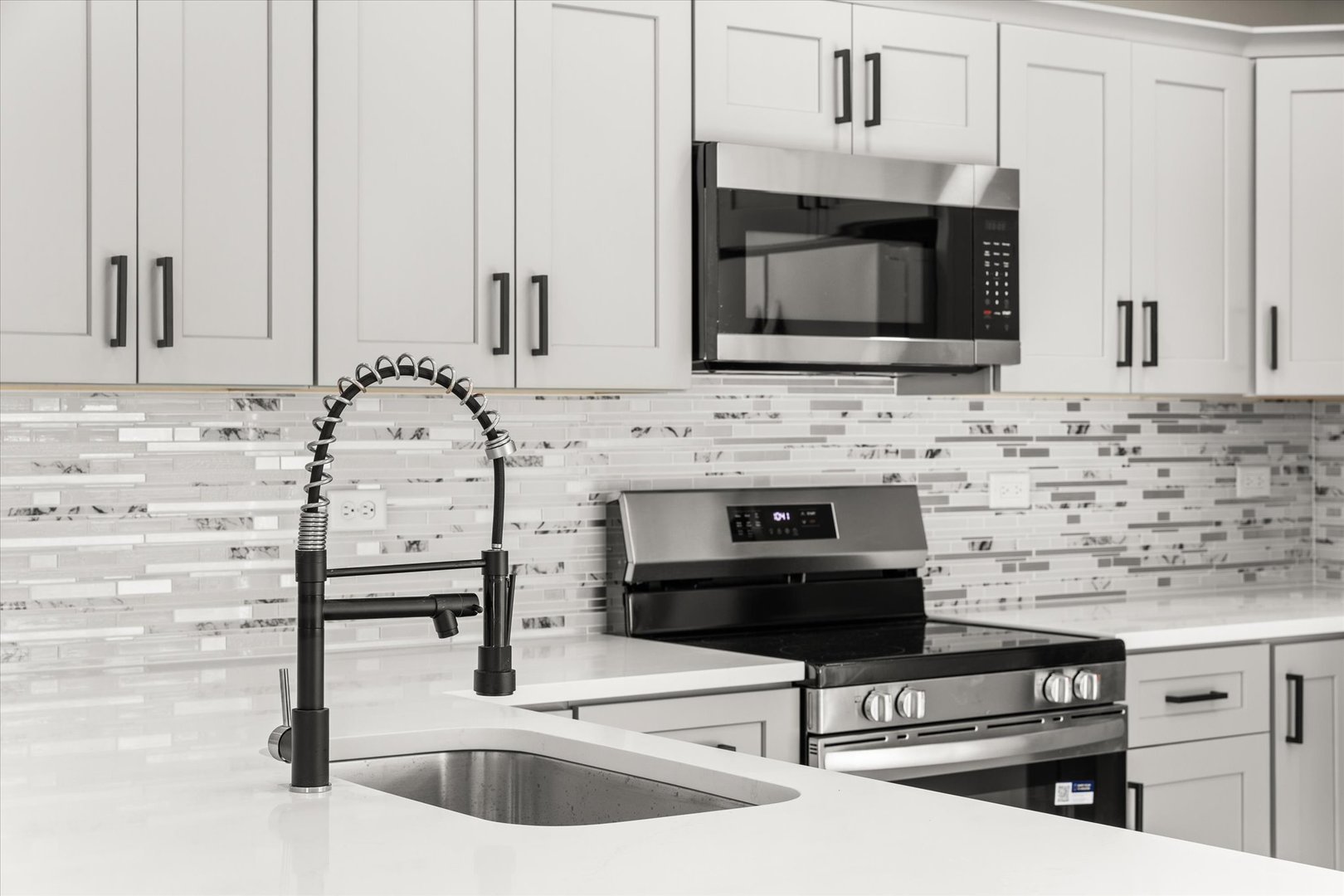 120 Kevin Drive Diamond, IL 60416 - Photo 16 of 24 a kitchen with granite countertop a stove microwave and sink