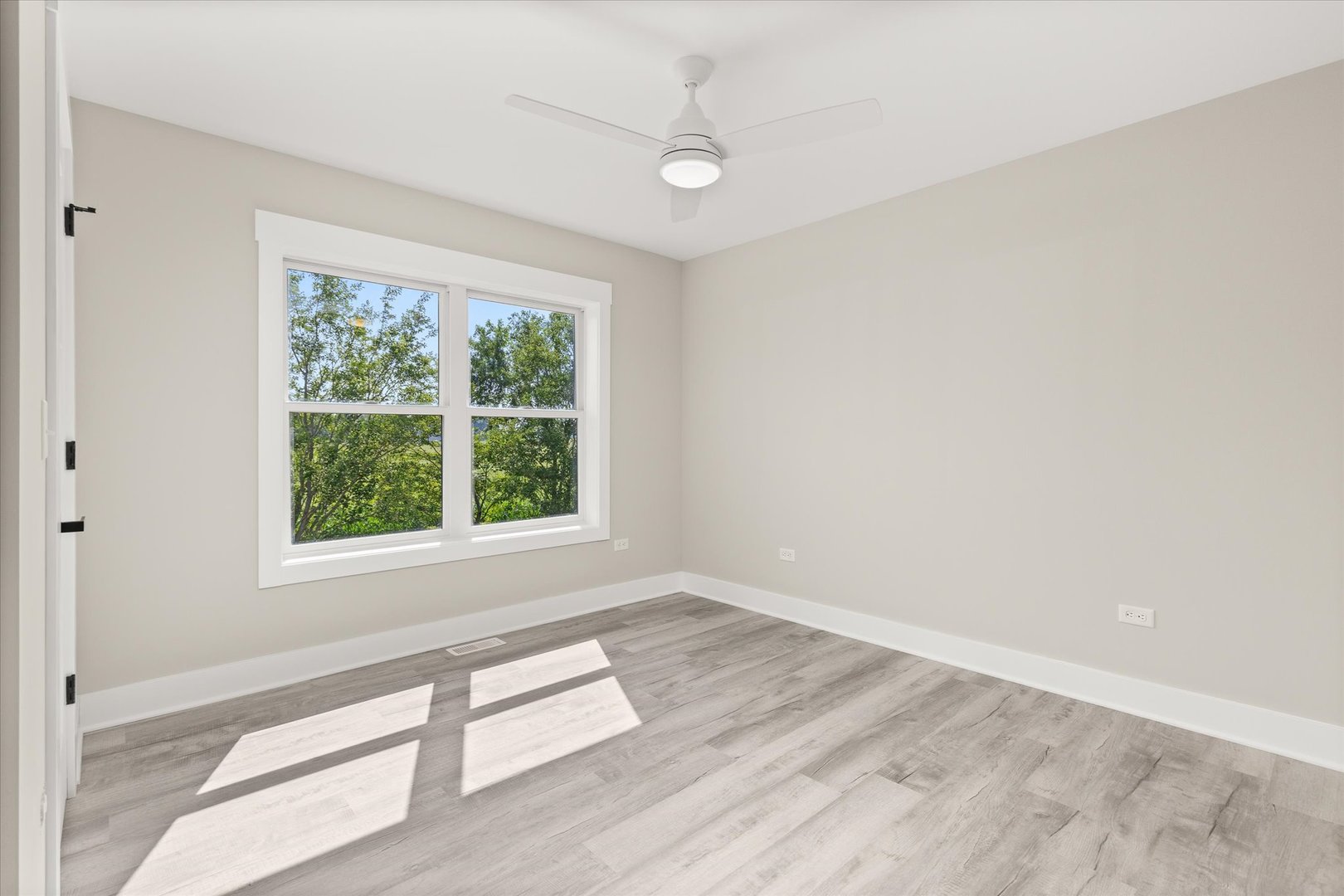 120 Kevin Drive Diamond, IL 60416 - Photo 21 of 24 an empty room with wooden floor and windows