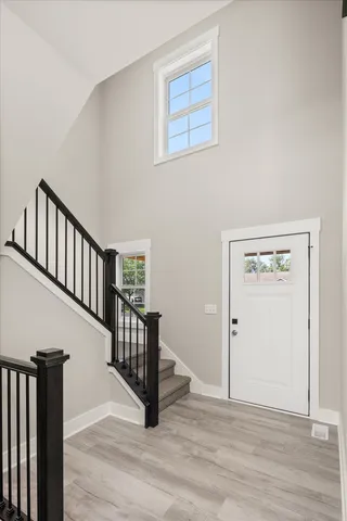 a view of an entryway with wooden floor