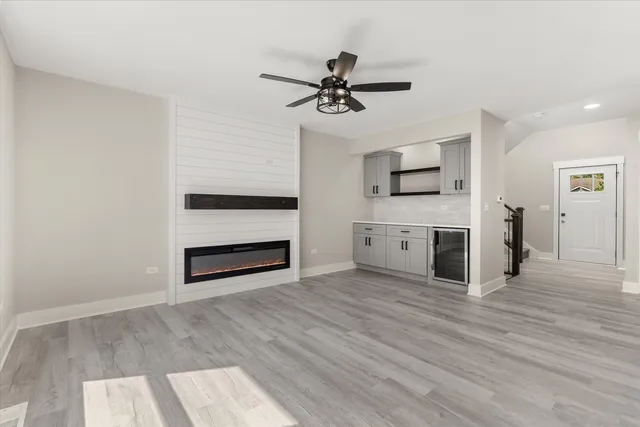 a view of a kitchen with a sink a cabinet and a fireplace