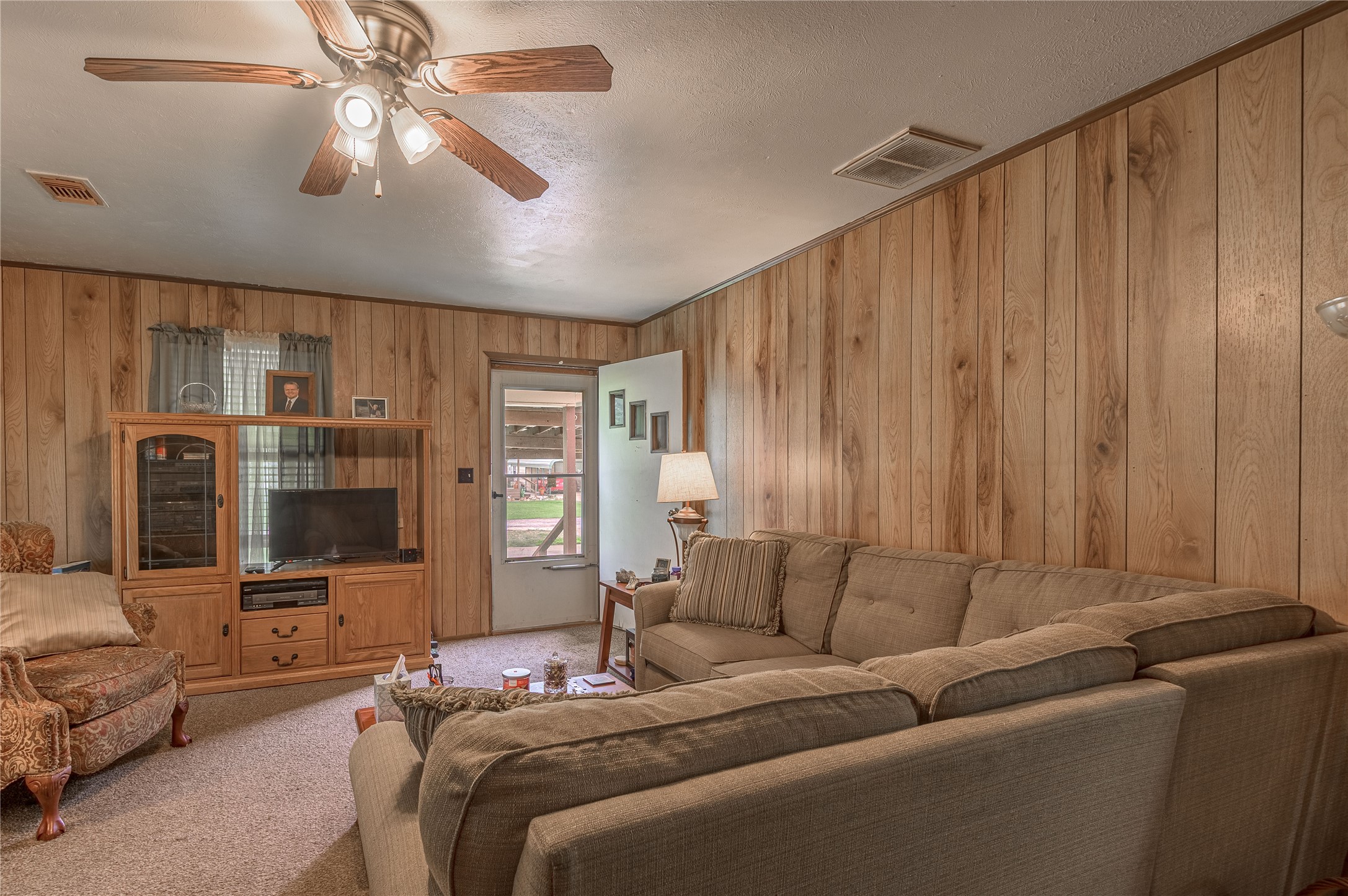 151 Moon Lake Drive Trinity, TX 75862 - Photo 16 of 46 a living room with furniture a flat screen tv and a ceiling fan