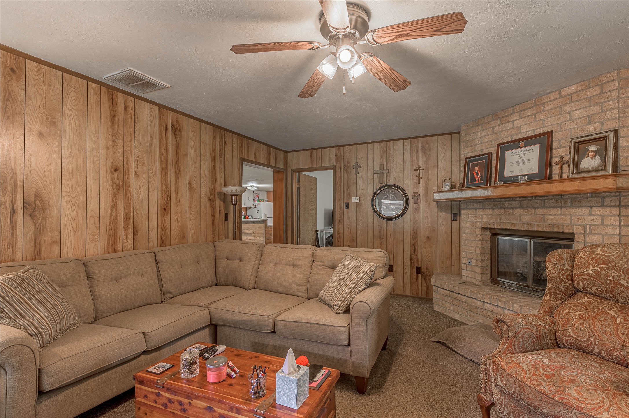 151 Moon Lake Drive Trinity, TX 75862 - Photo 17 of 46 a living room with furniture a fireplace and a chandelier