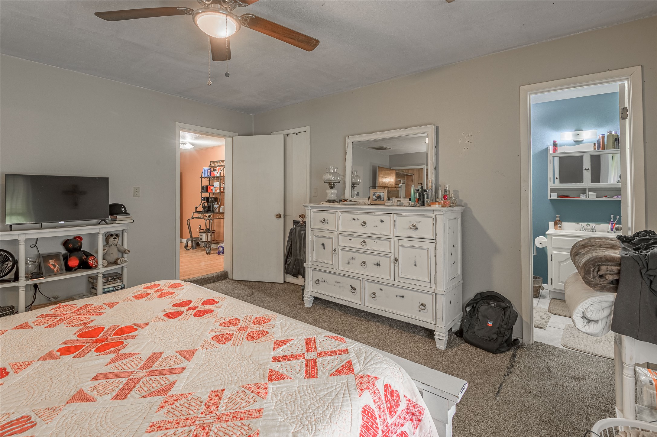 151 Moon Lake Drive Trinity, TX 75862 - Photo 22 of 46 a bedroom with a bed a dresser and a flat screen tv