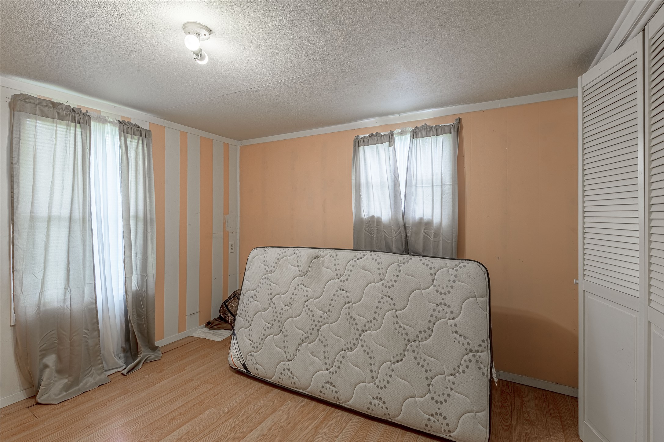 151 Moon Lake Drive Trinity, TX 75862 - Photo 25 of 46 an empty room with wooden floor and windows