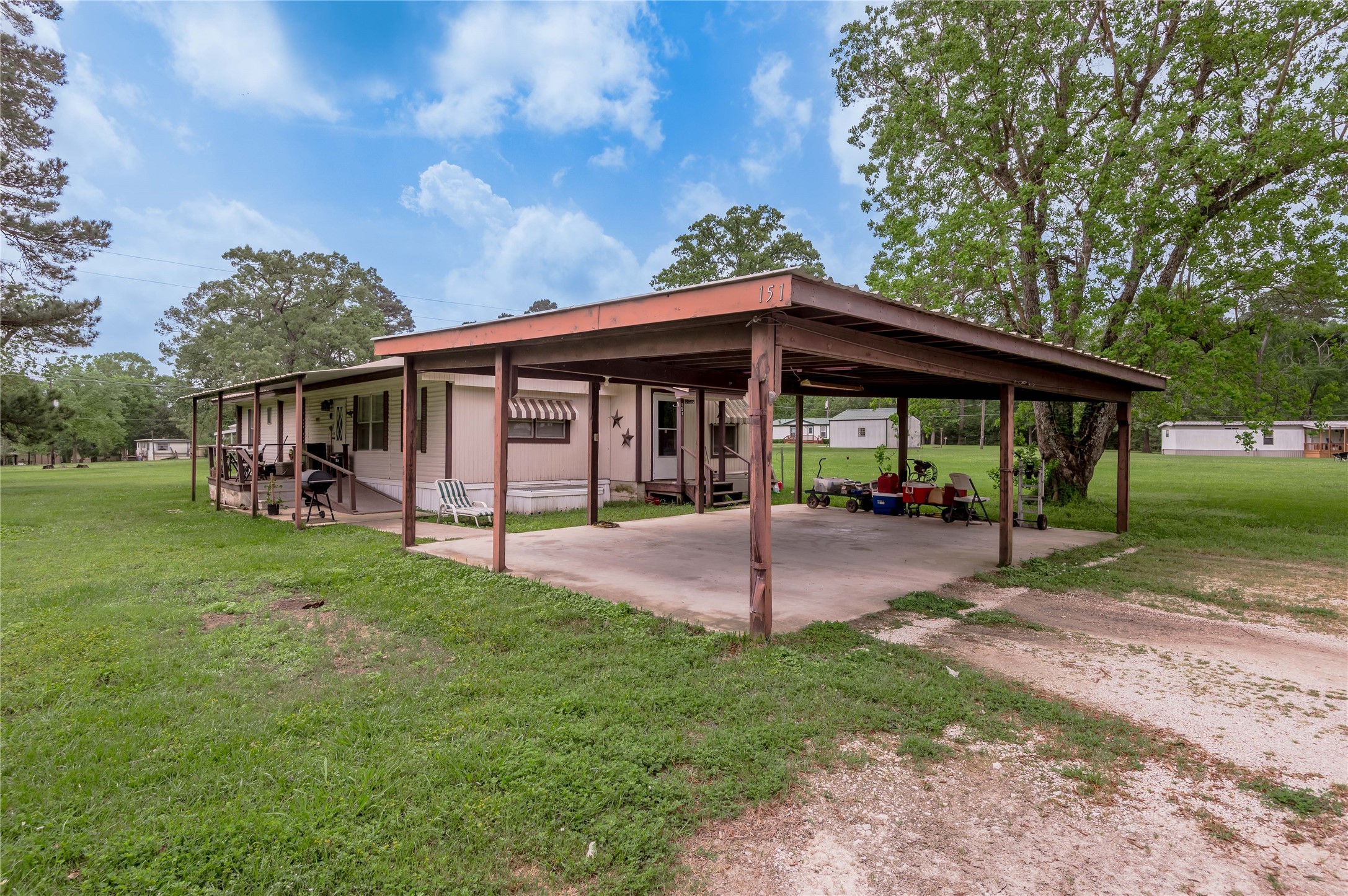 151 Moon Lake Drive Trinity, TX 75862 - Photo 29 of 46 a view of a house with a yard potted plants and large tree
