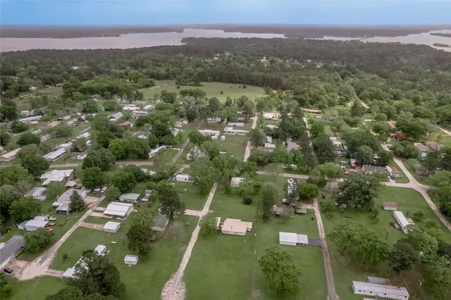 an aerial view of a house with a yard