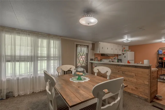 a view of a dining room with furniture and a large window