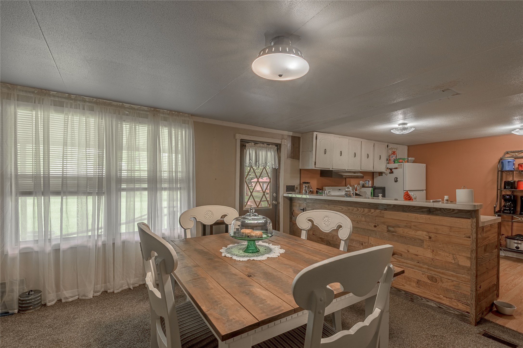 151 Moon Lake Drive Trinity, TX 75862 - Photo 8 of 46 a view of a dining room with furniture and a large window