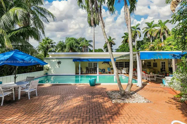 a view of a house with a yard and sitting area