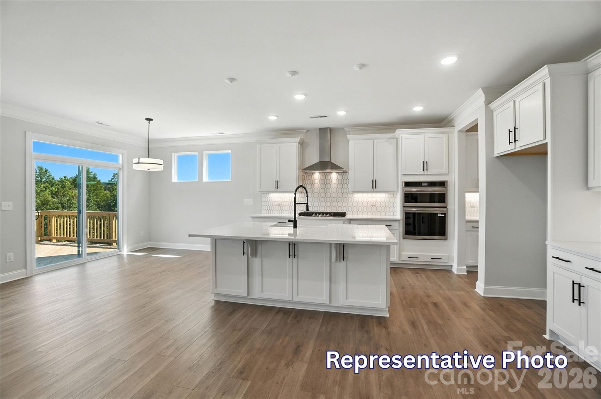 10818 Coble Road Mint Hill, NC 28227 - Photo 11 of 38 a kitchen with stainless steel appliances granite countertop a refrigerator a sink dishwasher a stove and a wooden floor