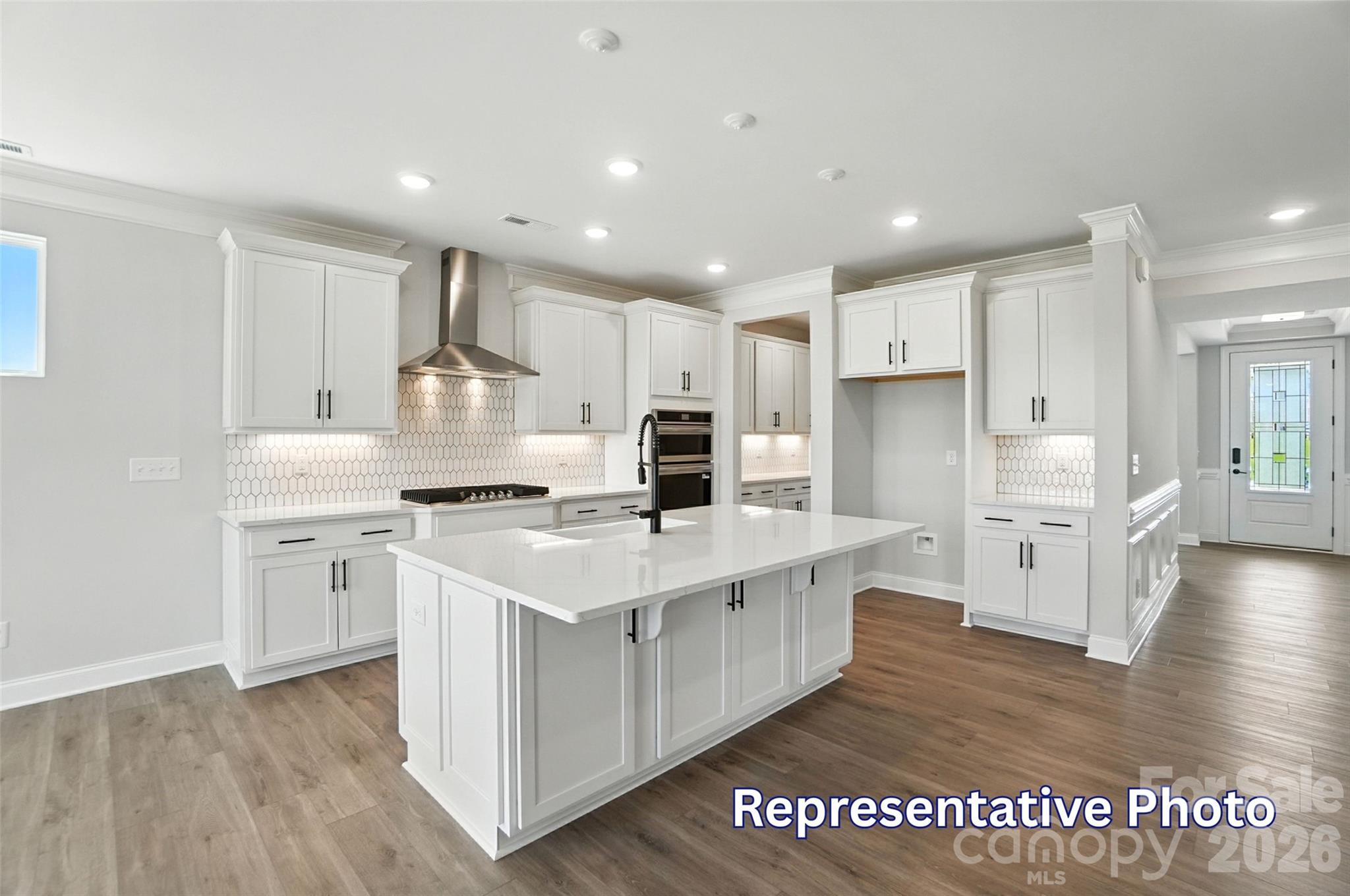10818 Coble Road Mint Hill, NC 28227 - Photo 12 of 38 a kitchen with white cabinets and stainless steel appliances