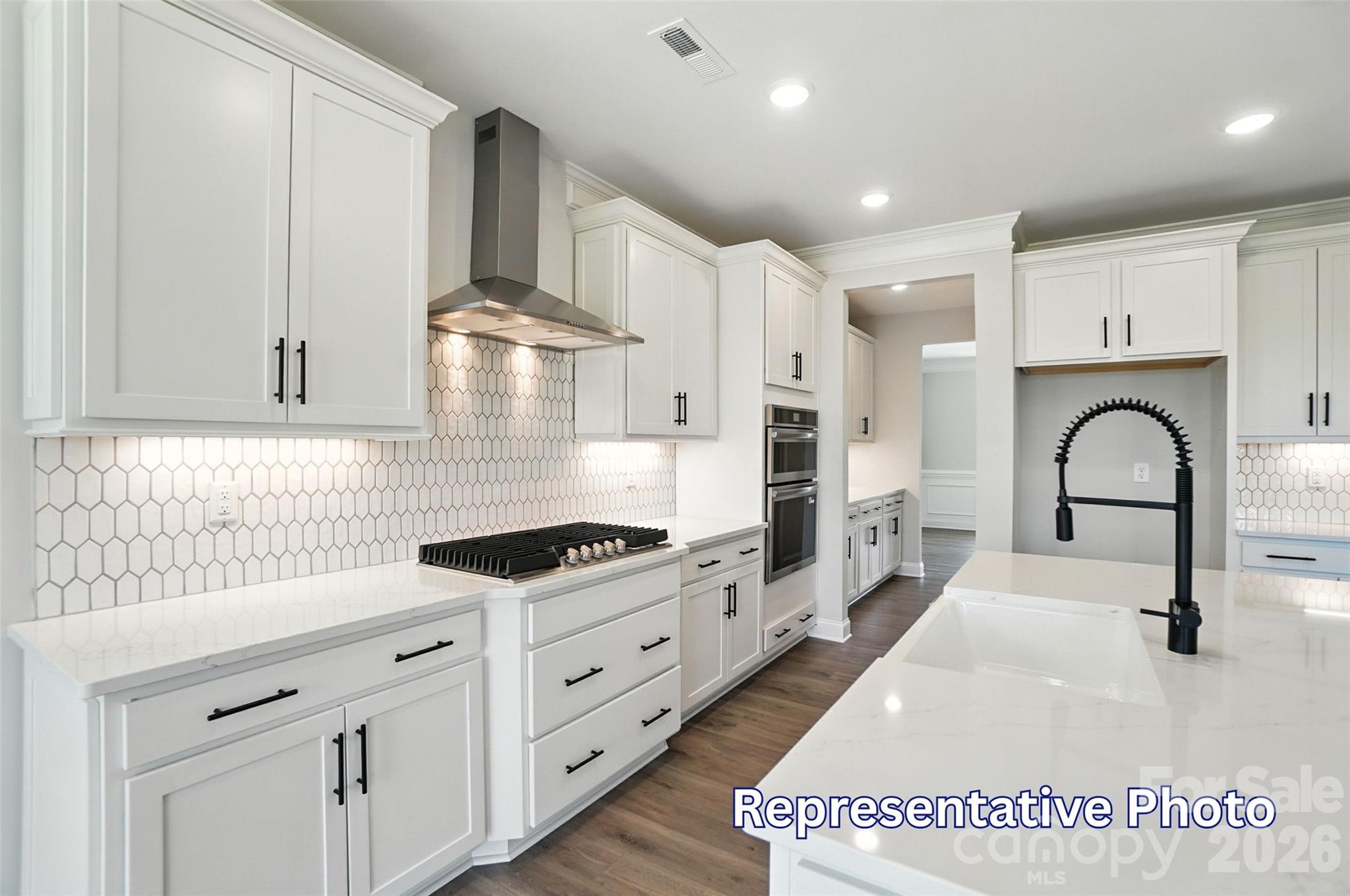 10818 Coble Road Mint Hill, NC 28227 - Photo 14 of 38 a kitchen with white cabinets and appliances