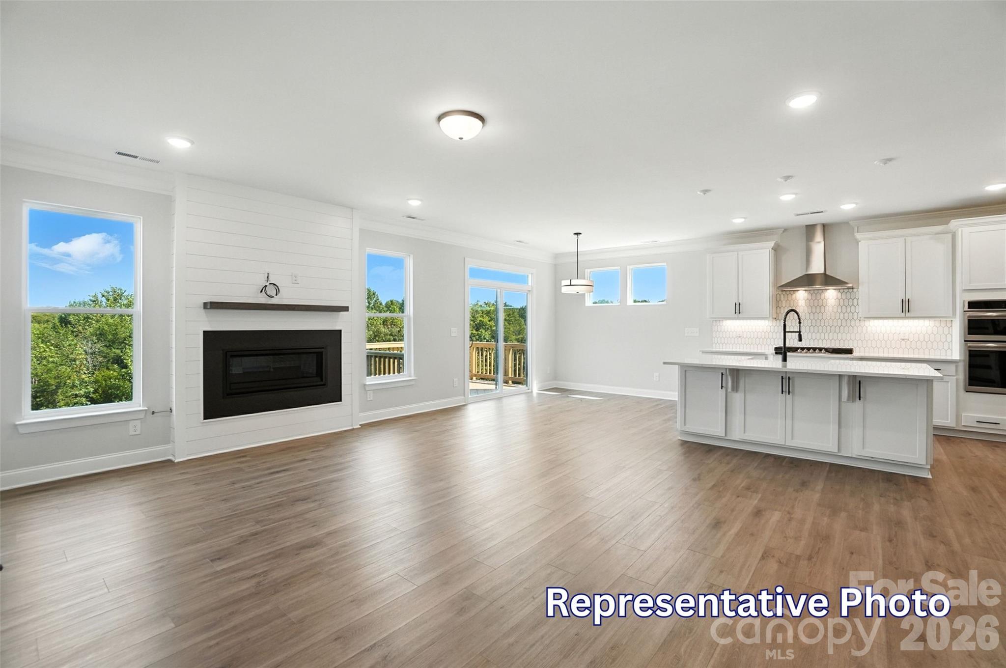 10818 Coble Road Mint Hill, NC 28227 - Photo 17 of 38 a large kitchen with stainless steel appliances kitchen island wooden floors and granite counter tops
