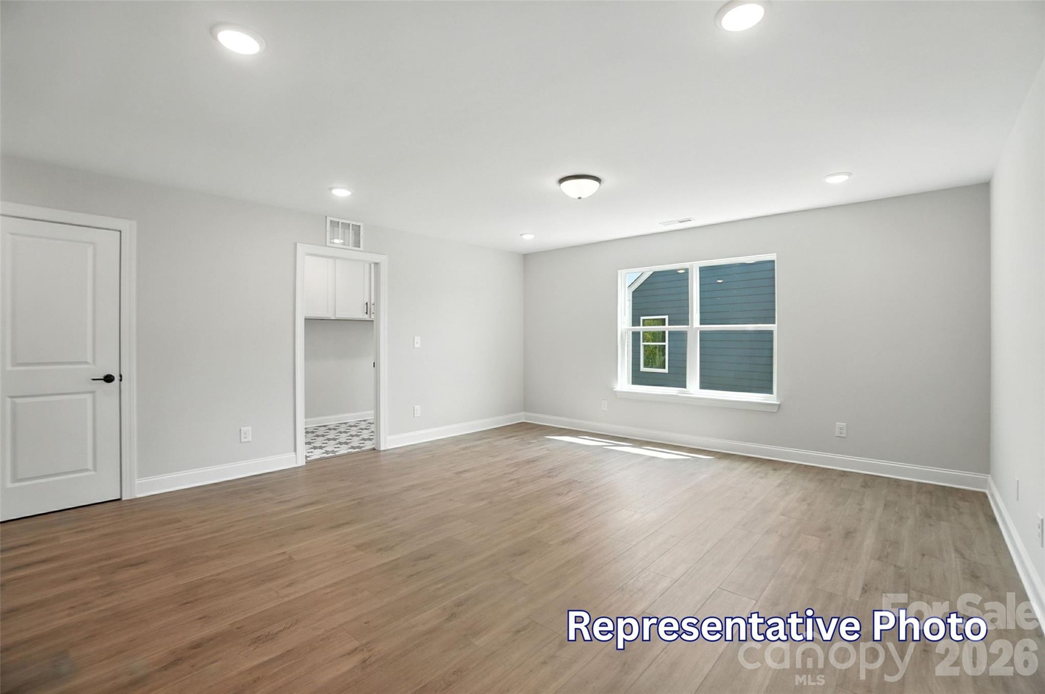 10818 Coble Road Mint Hill, NC 28227 - Photo 22 of 38 a view of an empty room with wooden floor and a window