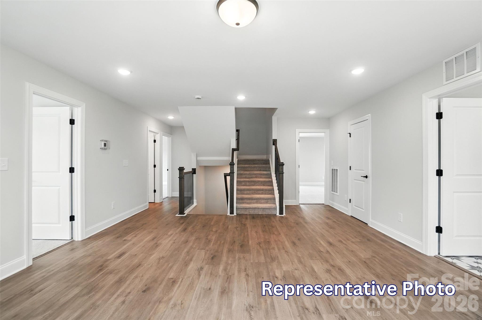 10818 Coble Road Mint Hill, NC 28227 - Photo 23 of 38 a view of an empty room with wooden floor
