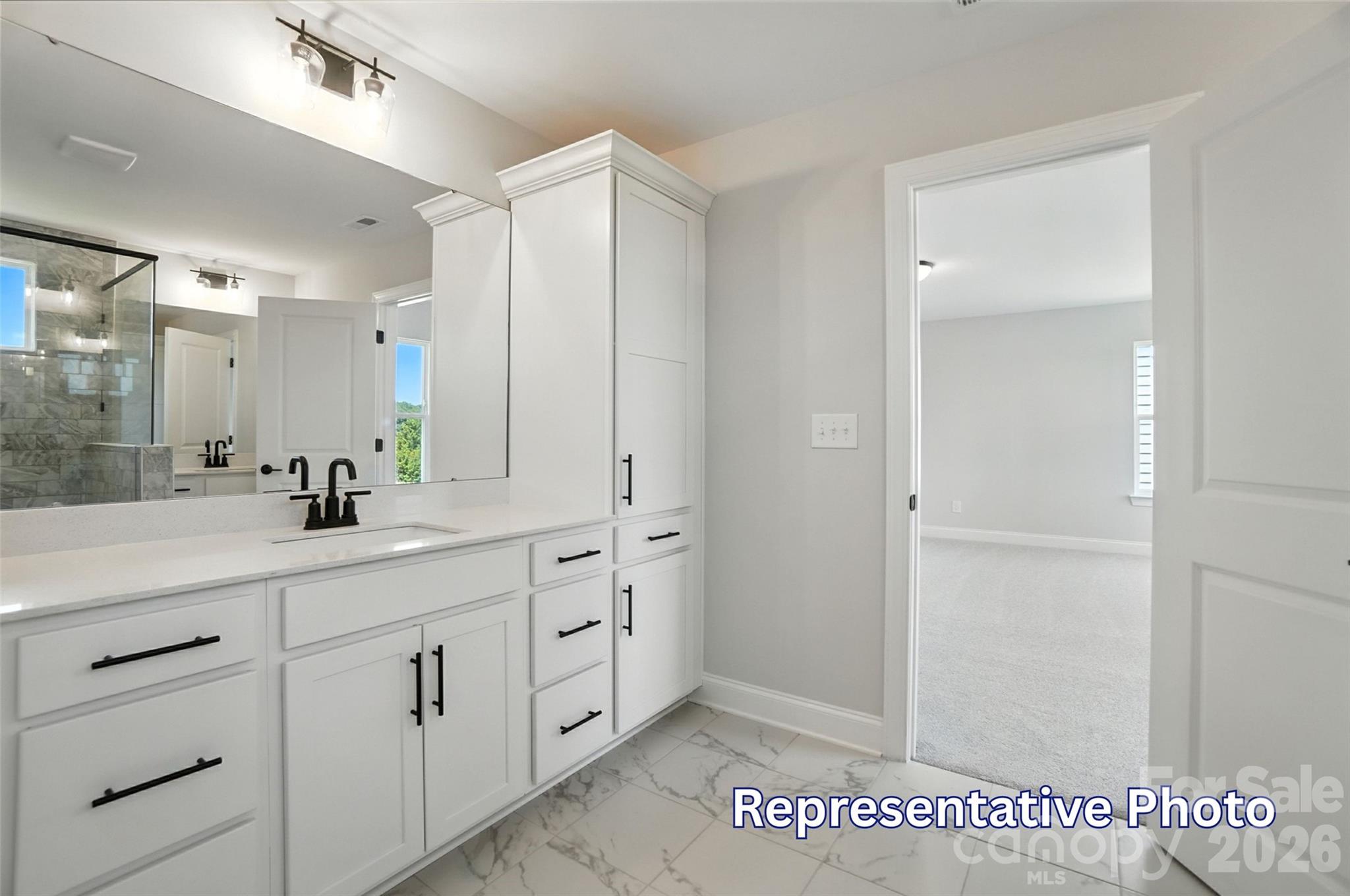10818 Coble Road Mint Hill, NC 28227 - Photo 30 of 38 a spacious bathroom with a shower a sink and a mirror