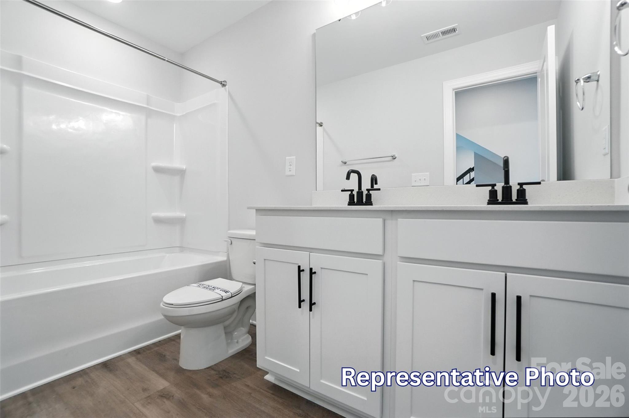 10818 Coble Road Mint Hill, NC 28227 - Photo 34 of 38 a bathroom with a sink toilet a mirror and shower