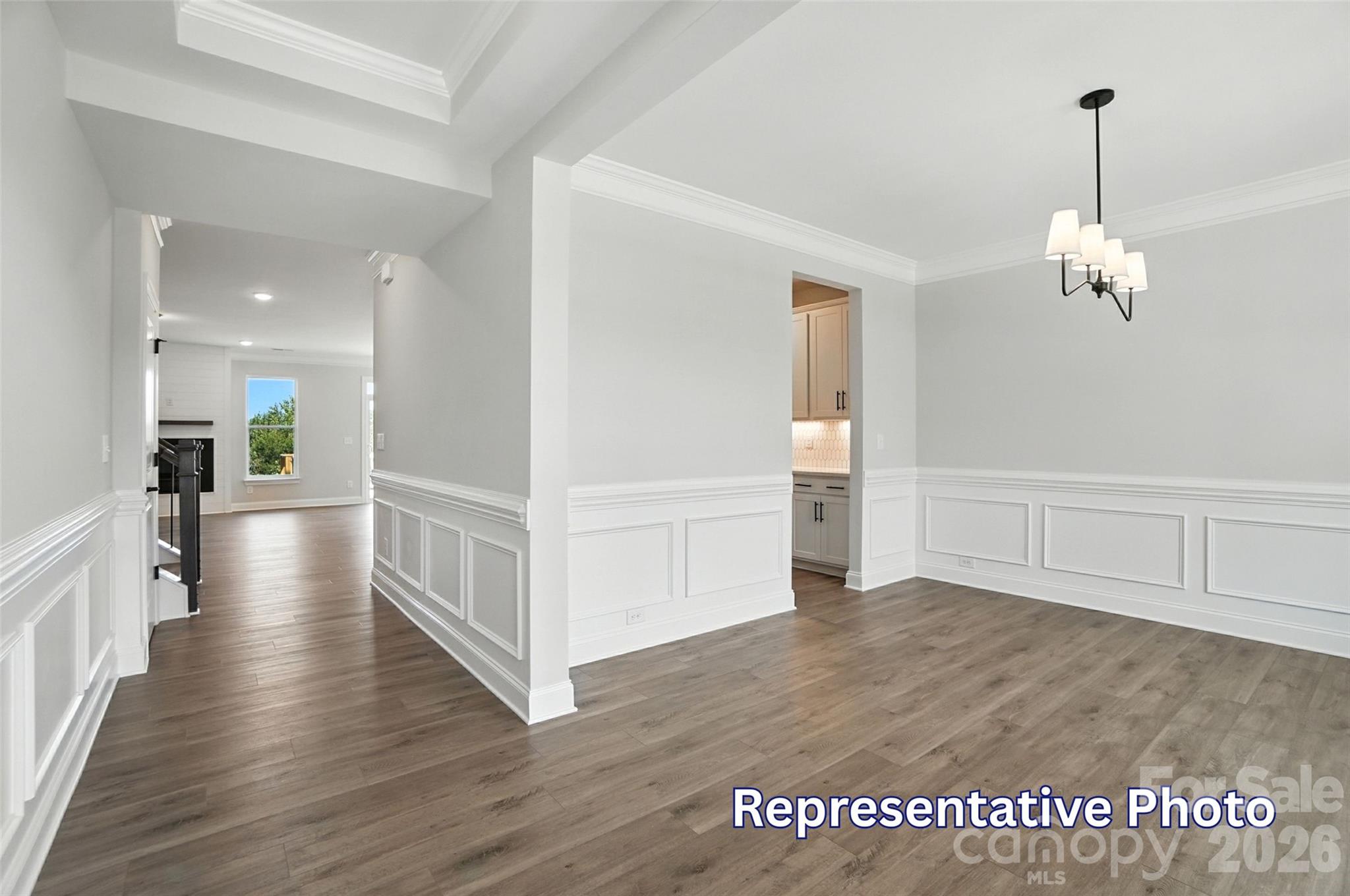 10818 Coble Road Mint Hill, NC 28227 - Photo 6 of 38 wooden floor in an empty room with a view of kitchen