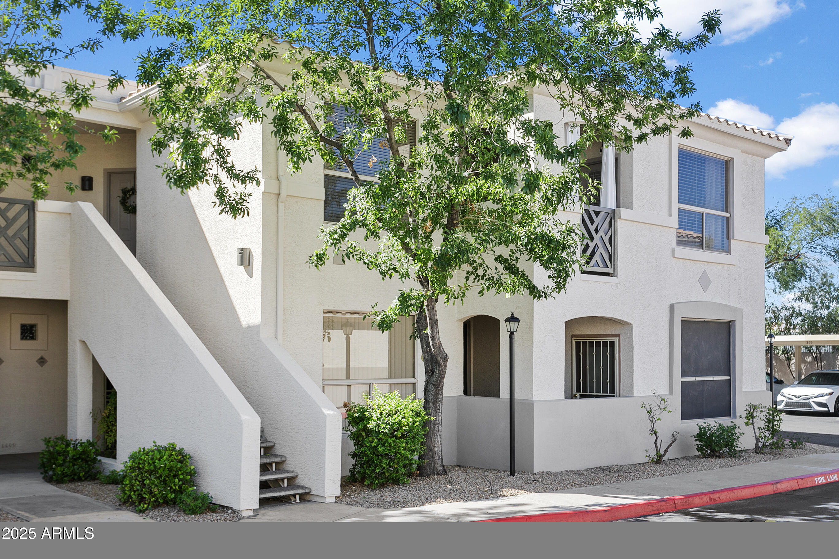9550 East Thunderbird Road, Unit 228 Scottsdale, AZ 85260 - Photo 1 of 29 a view of white house with a yard and large tree