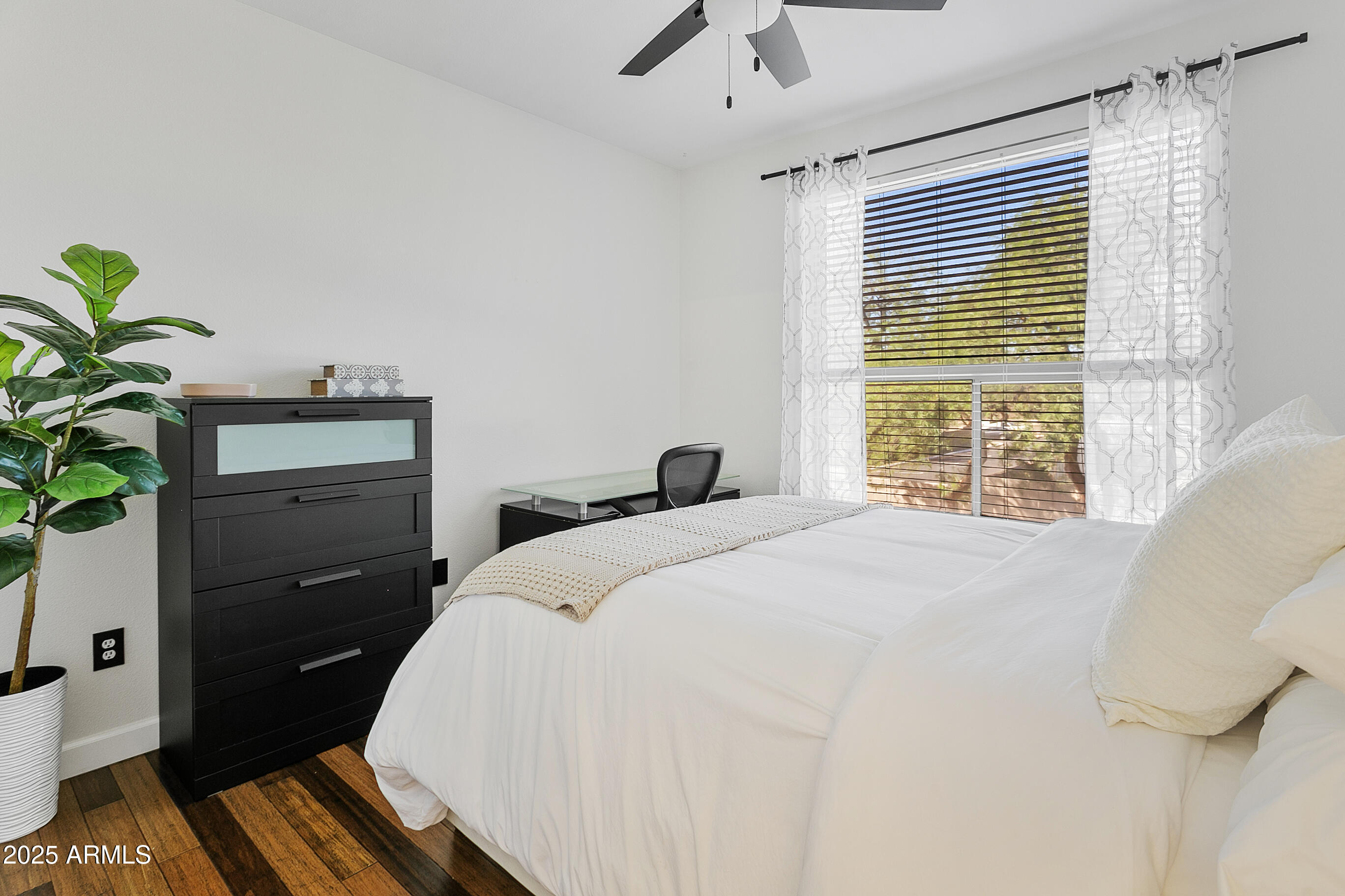 9550 East Thunderbird Road, Unit 228 Scottsdale, AZ 85260 - Photo 12 of 29 a spacious bedroom with a bed and a potted plant