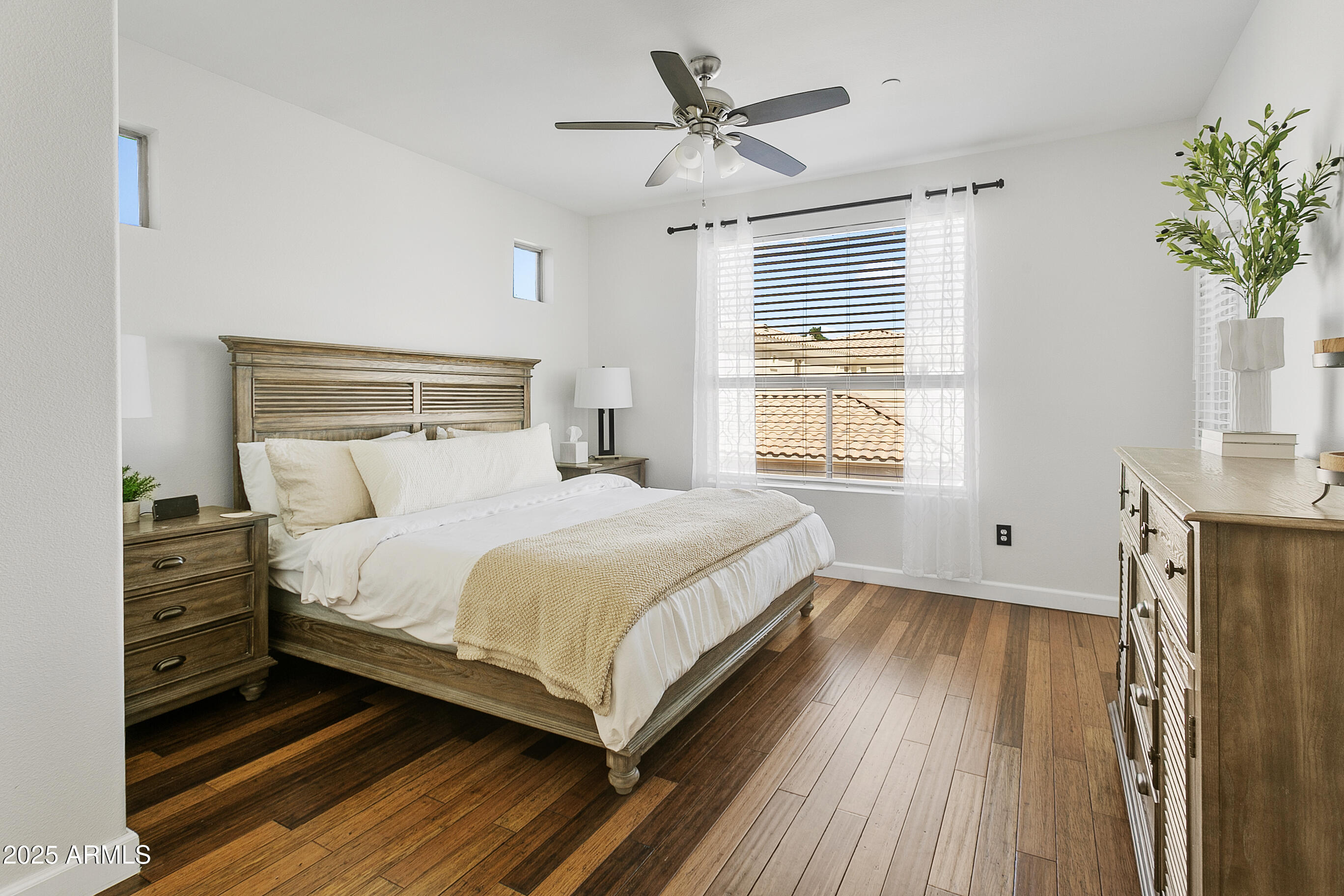 9550 East Thunderbird Road, Unit 228 Scottsdale, AZ 85260 - Photo 14 of 29 a bedroom with a bed and a potted plant on the dresser
