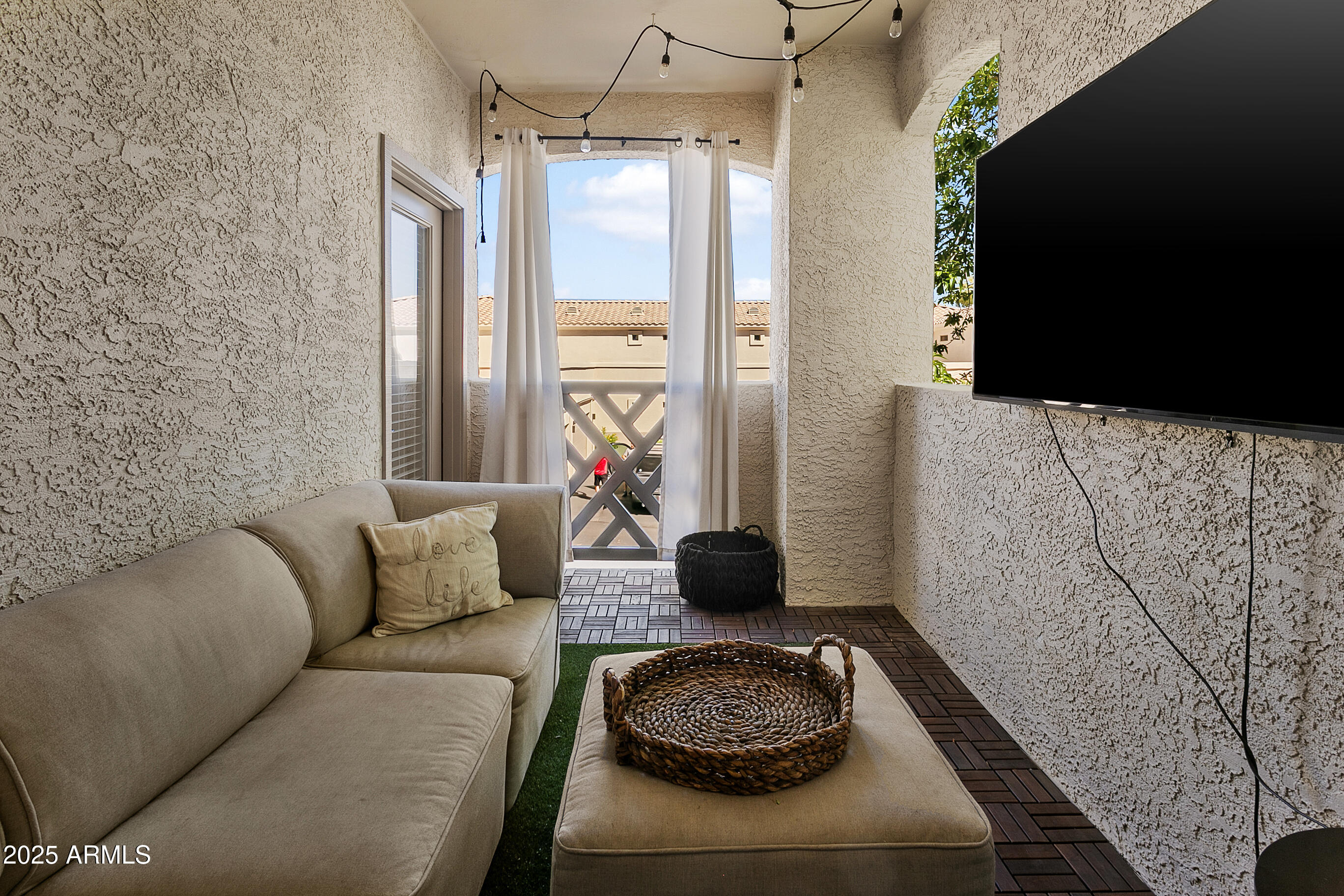 9550 East Thunderbird Road, Unit 228 Scottsdale, AZ 85260 - Photo 21 of 29 a living room with furniture and a flat screen tv