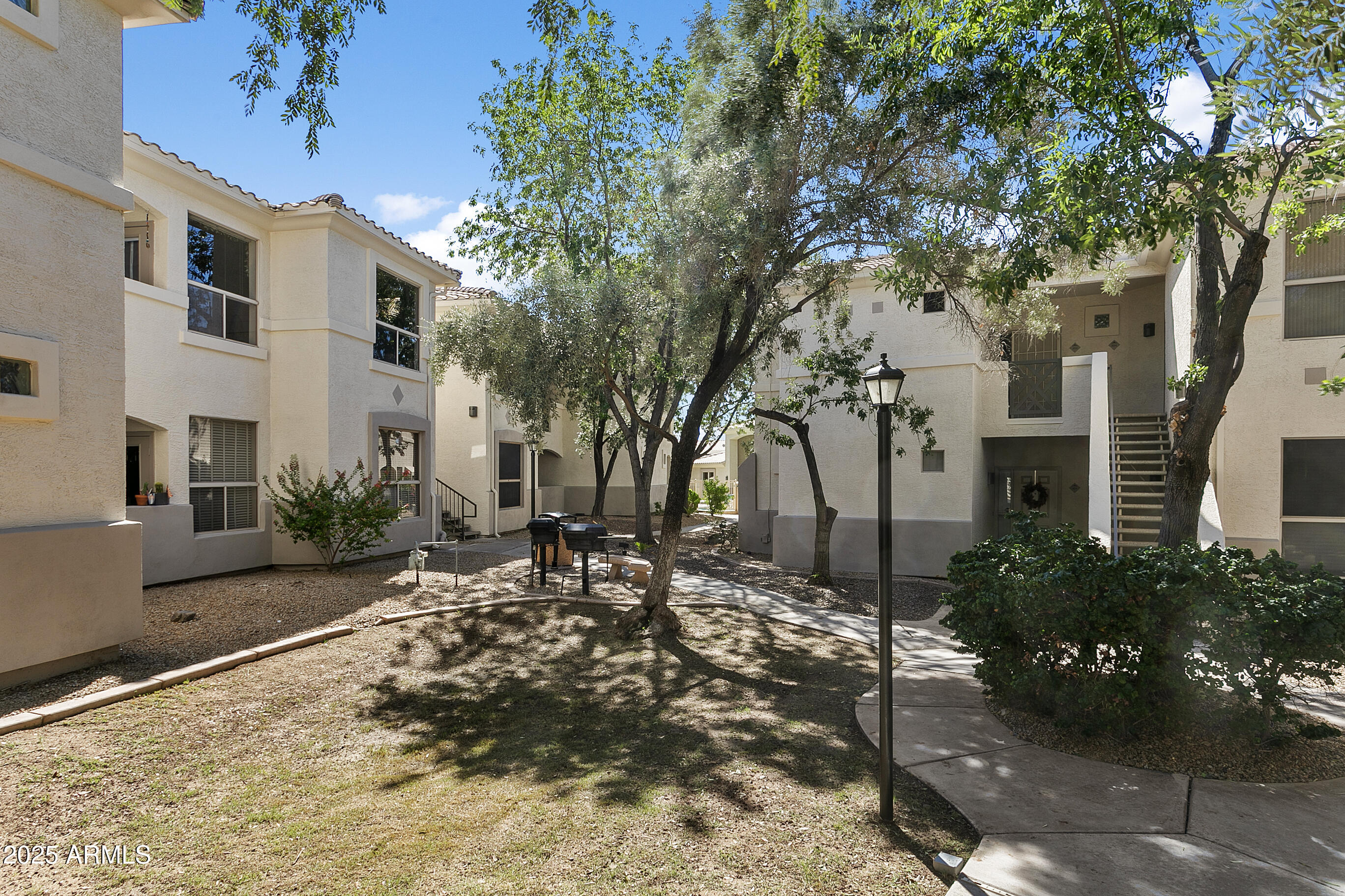 9550 East Thunderbird Road, Unit 228 Scottsdale, AZ 85260 - Photo 23 of 29 a view of a house with a tree in the yard