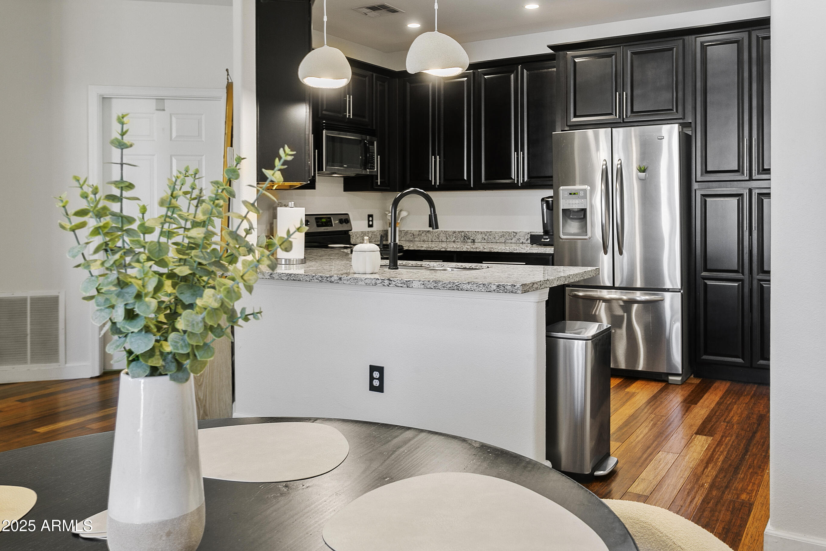 9550 East Thunderbird Road, Unit 228 Scottsdale, AZ 85260 - Photo 7 of 29 a kitchen with stainless steel appliances a sink a refrigerator a stove a microwave and cabinets