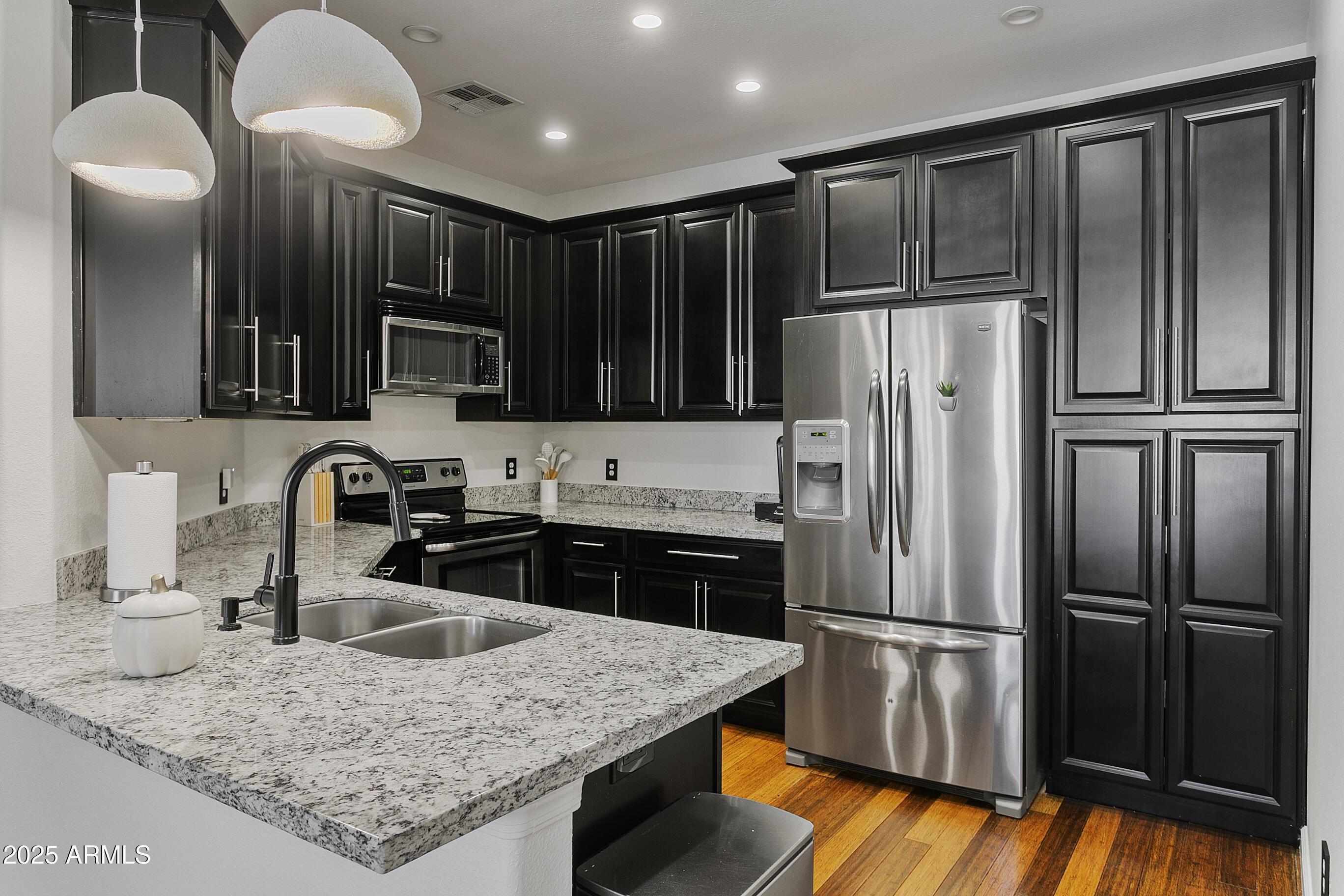 9550 East Thunderbird Road, Unit 228 Scottsdale, AZ 85260 - Photo 8 of 29 a kitchen with kitchen island granite countertop stainless steel appliances and refrigerator