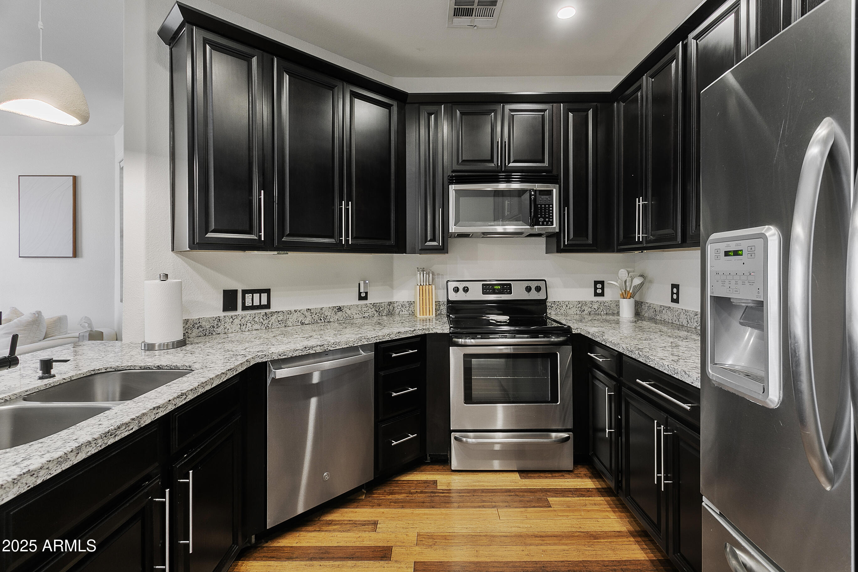 9550 East Thunderbird Road, Unit 228 Scottsdale, AZ 85260 - Photo 9 of 29 a kitchen with stainless steel appliances granite countertop a sink stove and refrigerator