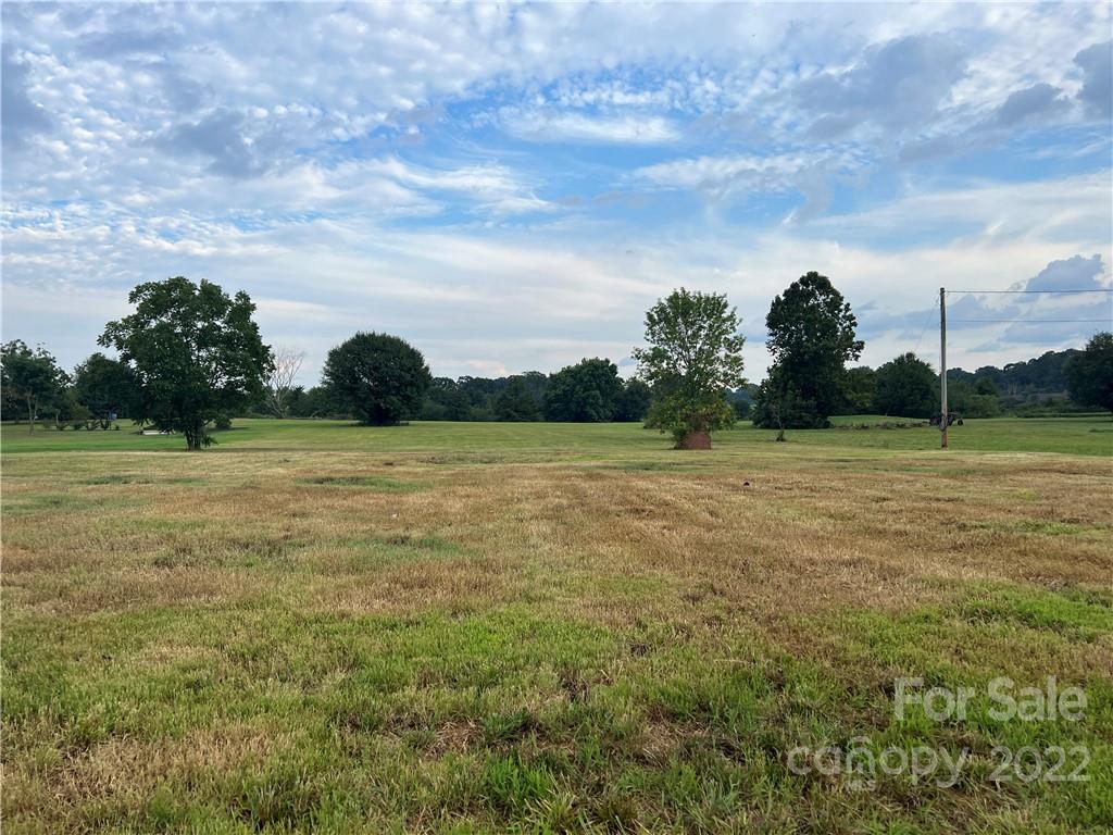 2421 Long Hope Road Monroe, NC 28112 - Photo 2 of 14 a view of a garden with a building in the background