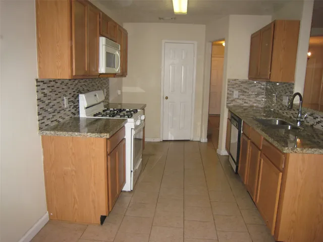 a kitchen with a stove and a refrigerator