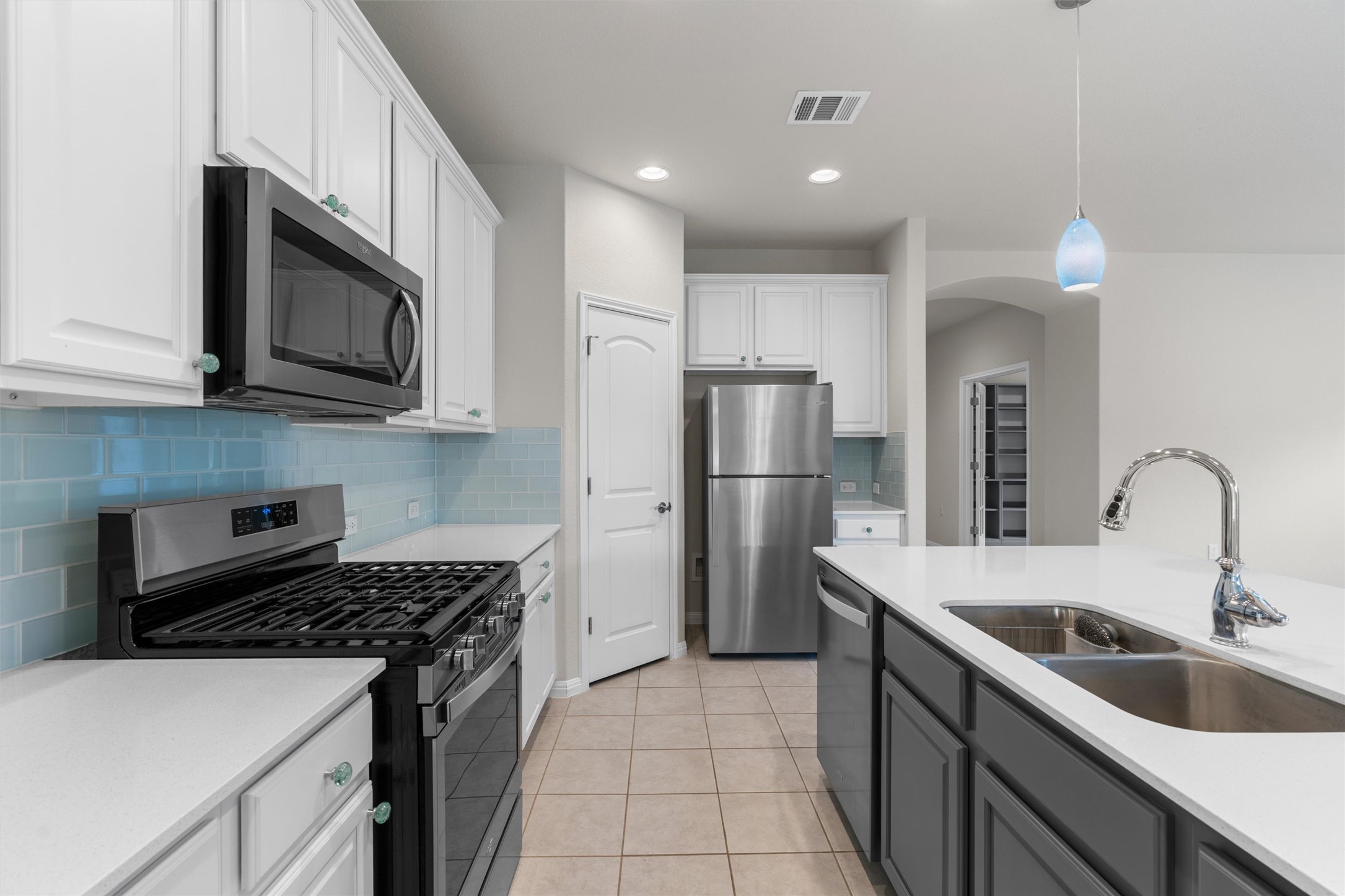 108 Calhoun Lane Georgetown, TX 78633 - Photo 12 of 32 a kitchen with a sink a stove and refrigerator