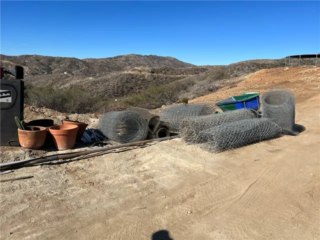 a view of a backyard with wooden fence and a mountain view
