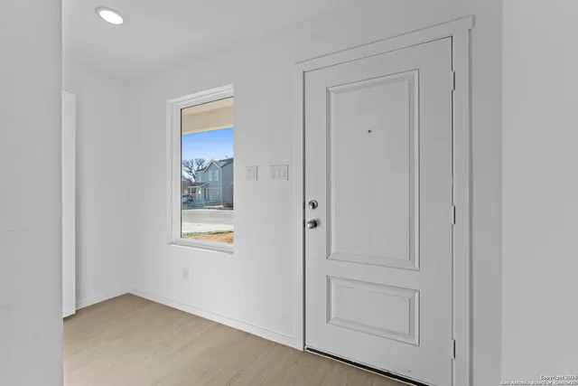 an empty room with windows and closet