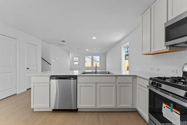 a kitchen with stainless steel appliances granite countertop a sink and cabinets