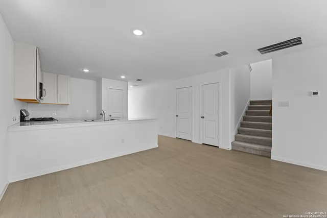 a view of kitchen with wooden floor and electronic appliances