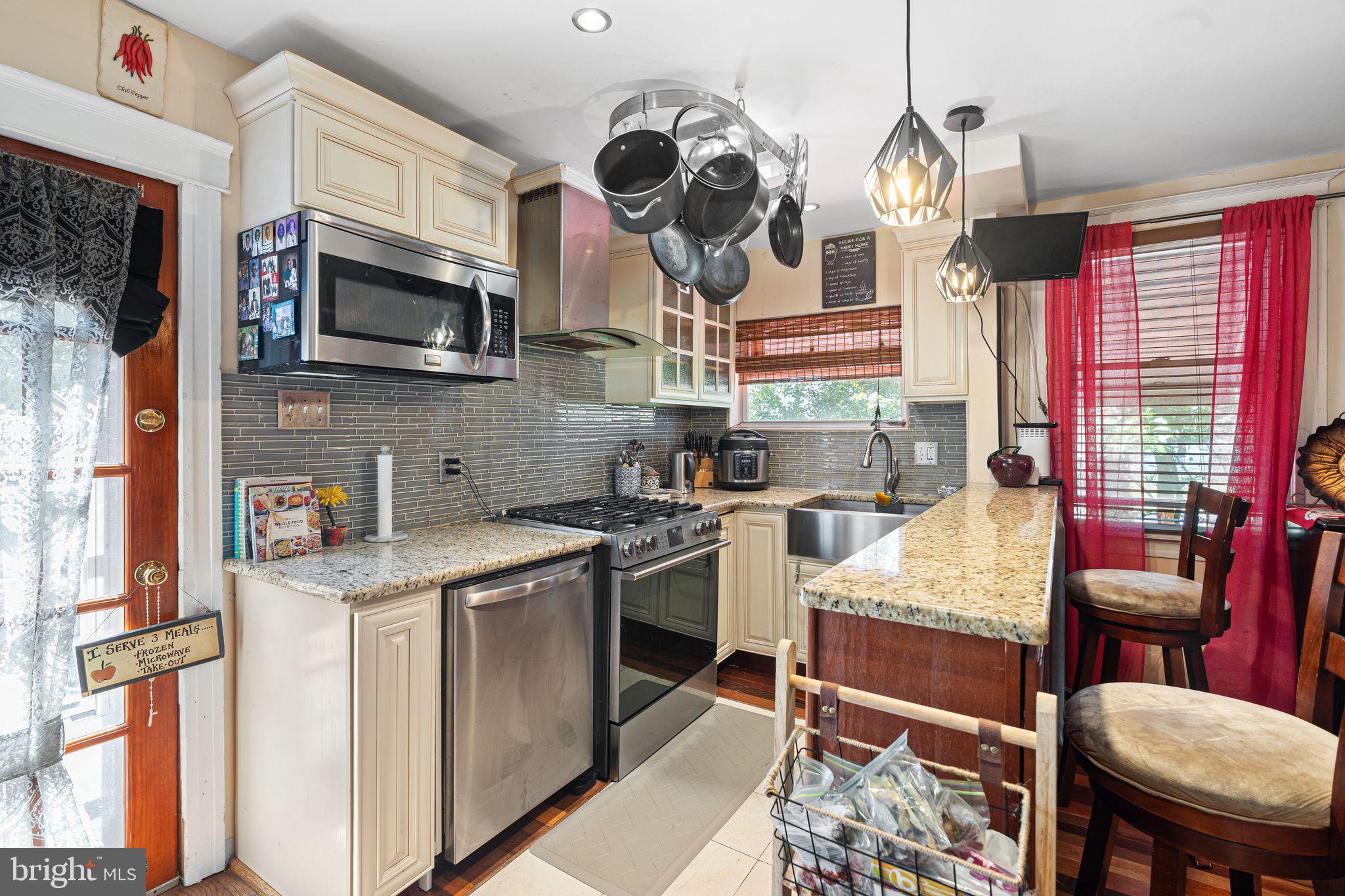 144 Fairview Avenue Lansdowne, PA 19050 - Photo 12 of 39 a kitchen with stainless steel appliances granite countertop a stove top oven a sink dishwasher and white cabinets