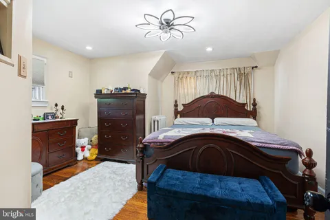 a bedroom with a bed and a mirror